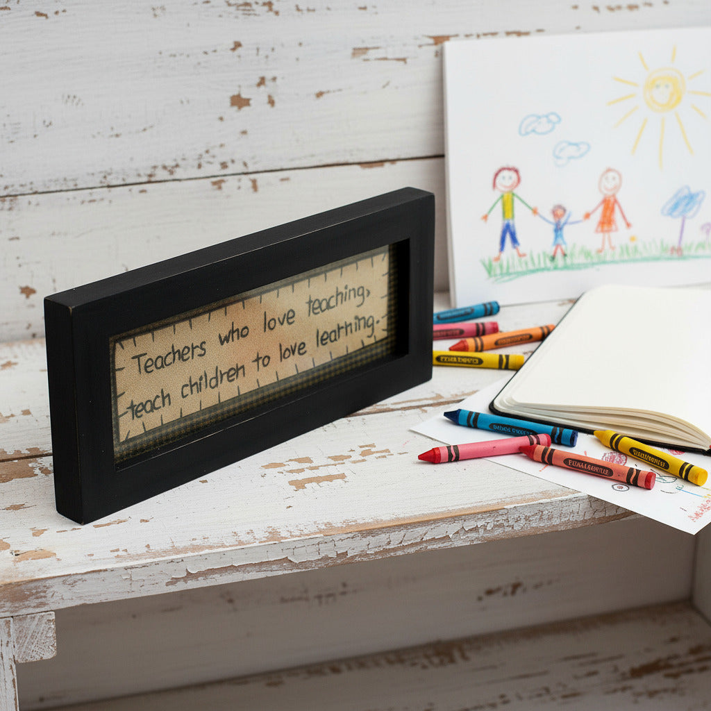 Primitive stitchery sign that reads Teachers who love teaching teach children to love learning