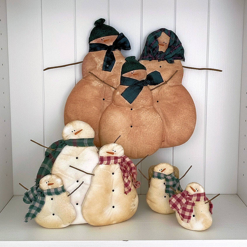Set of decorative snowmen with plaid scarves on a white background