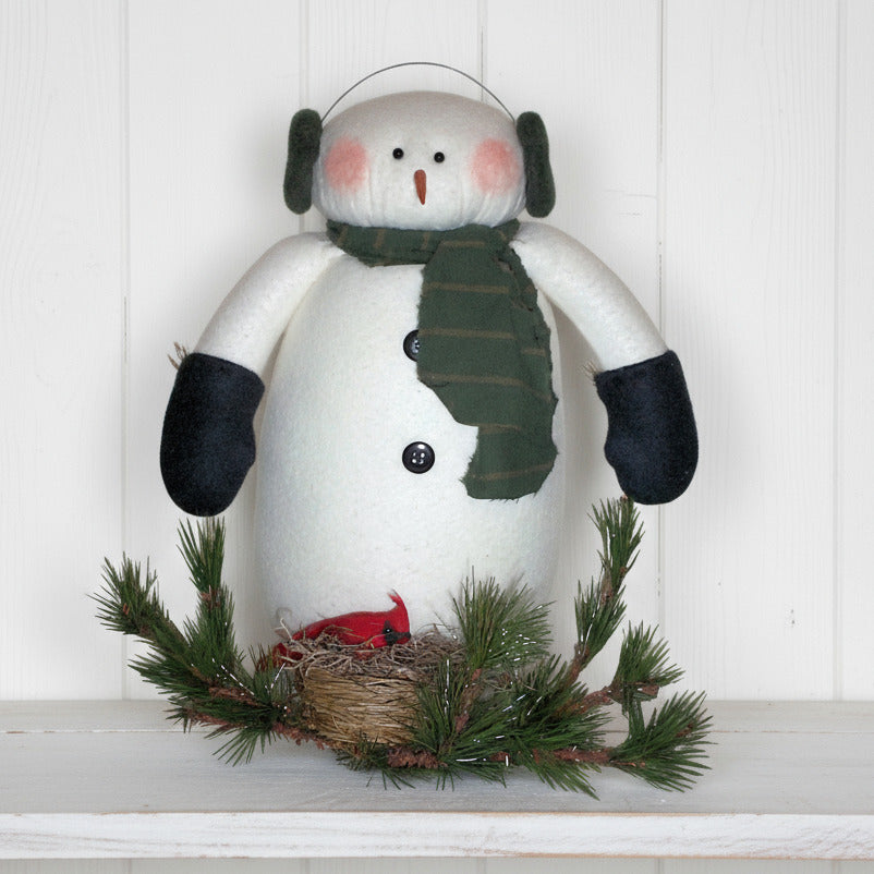 Decorative snowman with a green scarf, black gloves, and a red bird on a white background