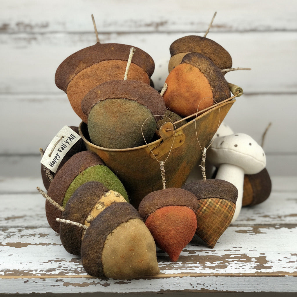 Decorative acorn ornaments with a metal bucket on a white background