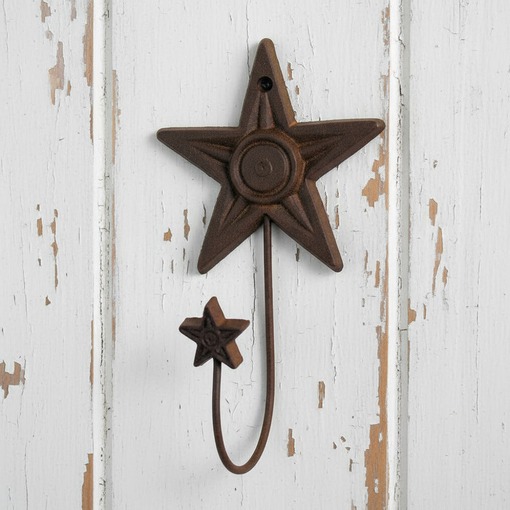 Decorative metal star hook on a white background