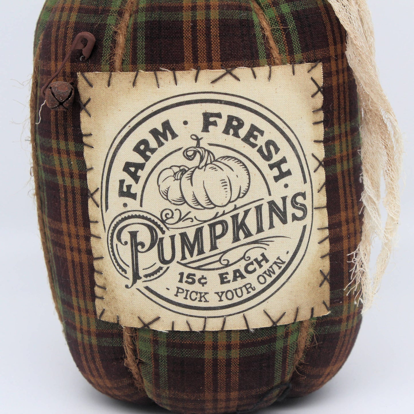 Grungy handmade homespun fabric pumpkin with muslin label that reads farm fresh pumpkins