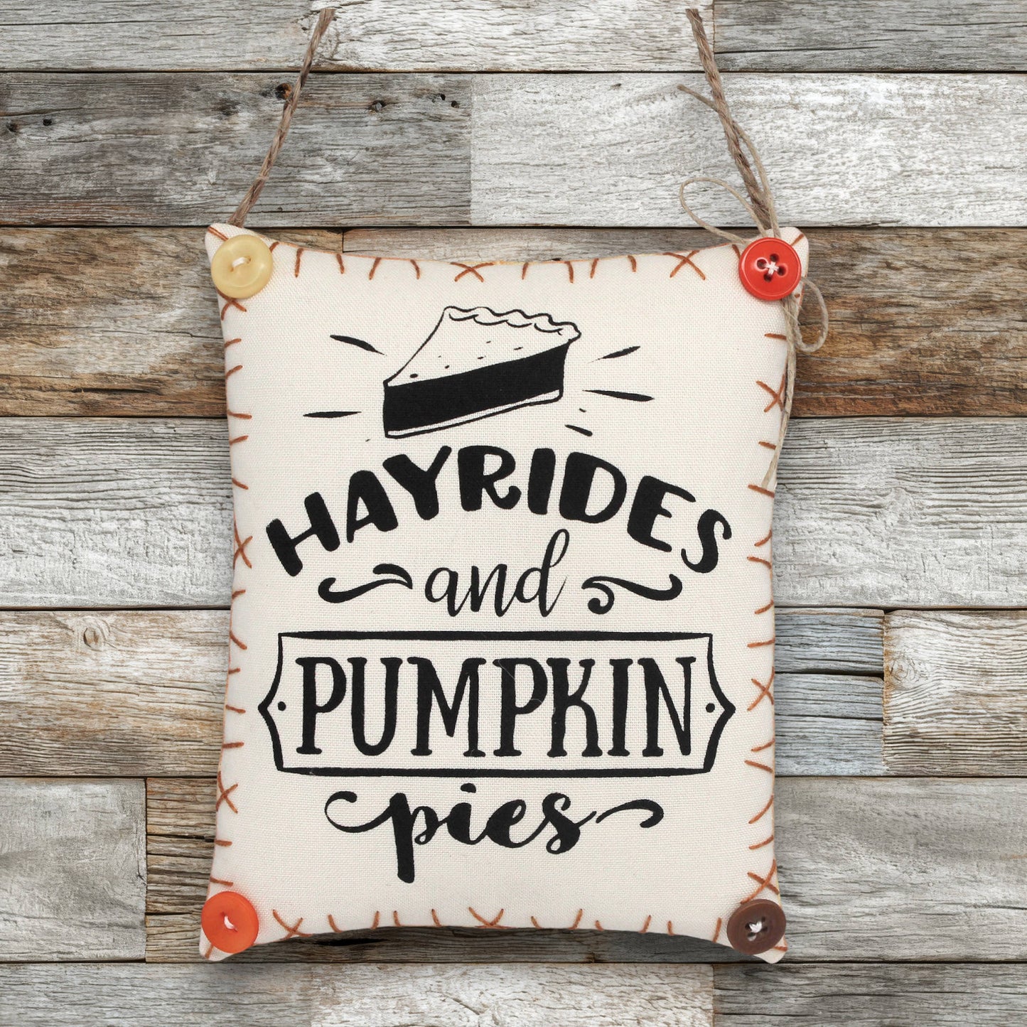 Decorative sign ornament with 'Hayrides and Pumpkin Pies' text on a wooden background