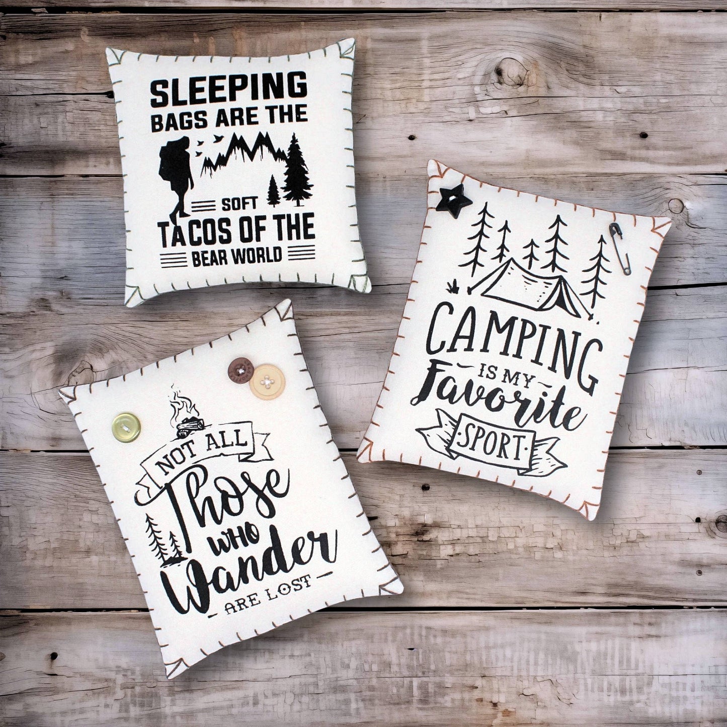 Set of three screen-printed mini pillows with adventure-themed designs for camping or cabin decorating