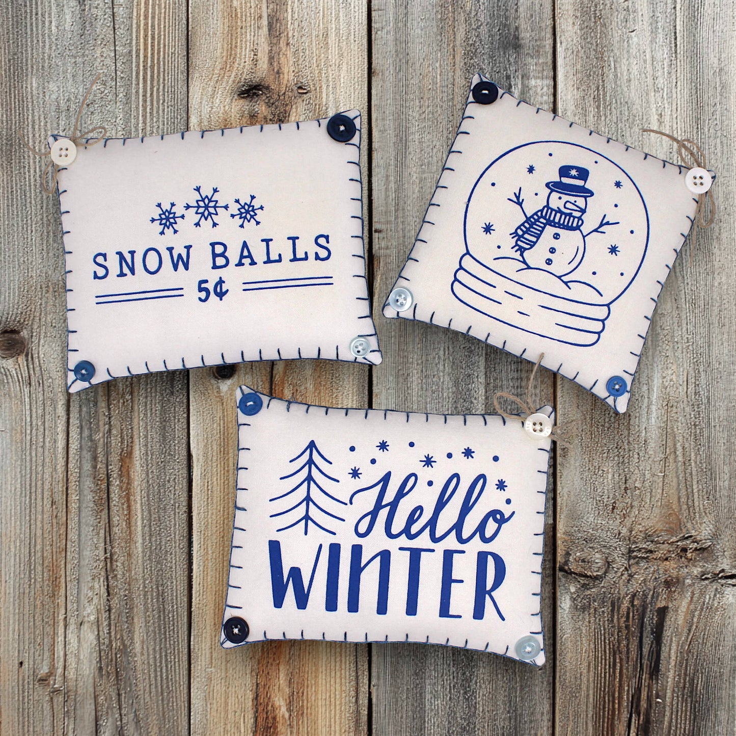 Set of three mini pillow bowl fillers with snowman and winter-themed text and graphics