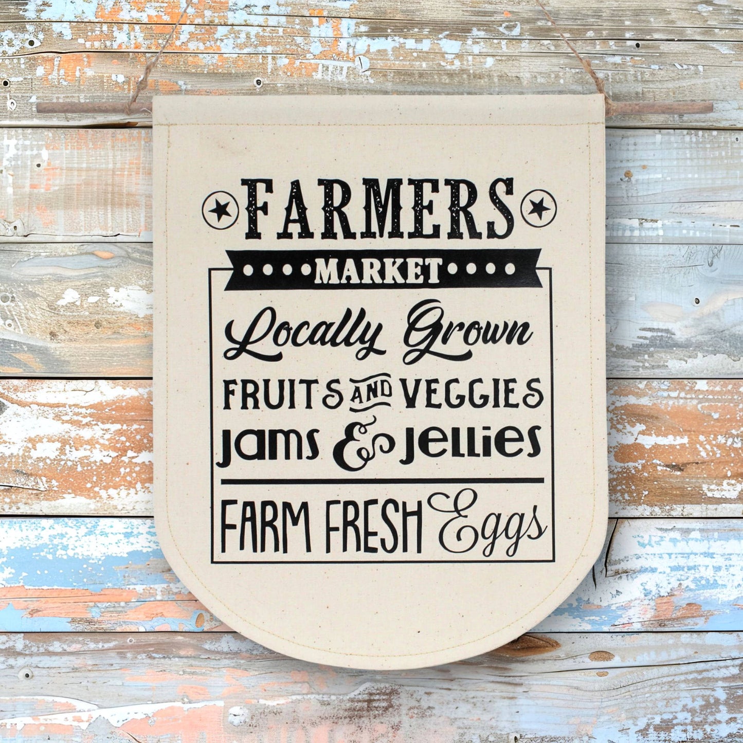 Fabric wall banner with text about farmers market on a rustic wooden background