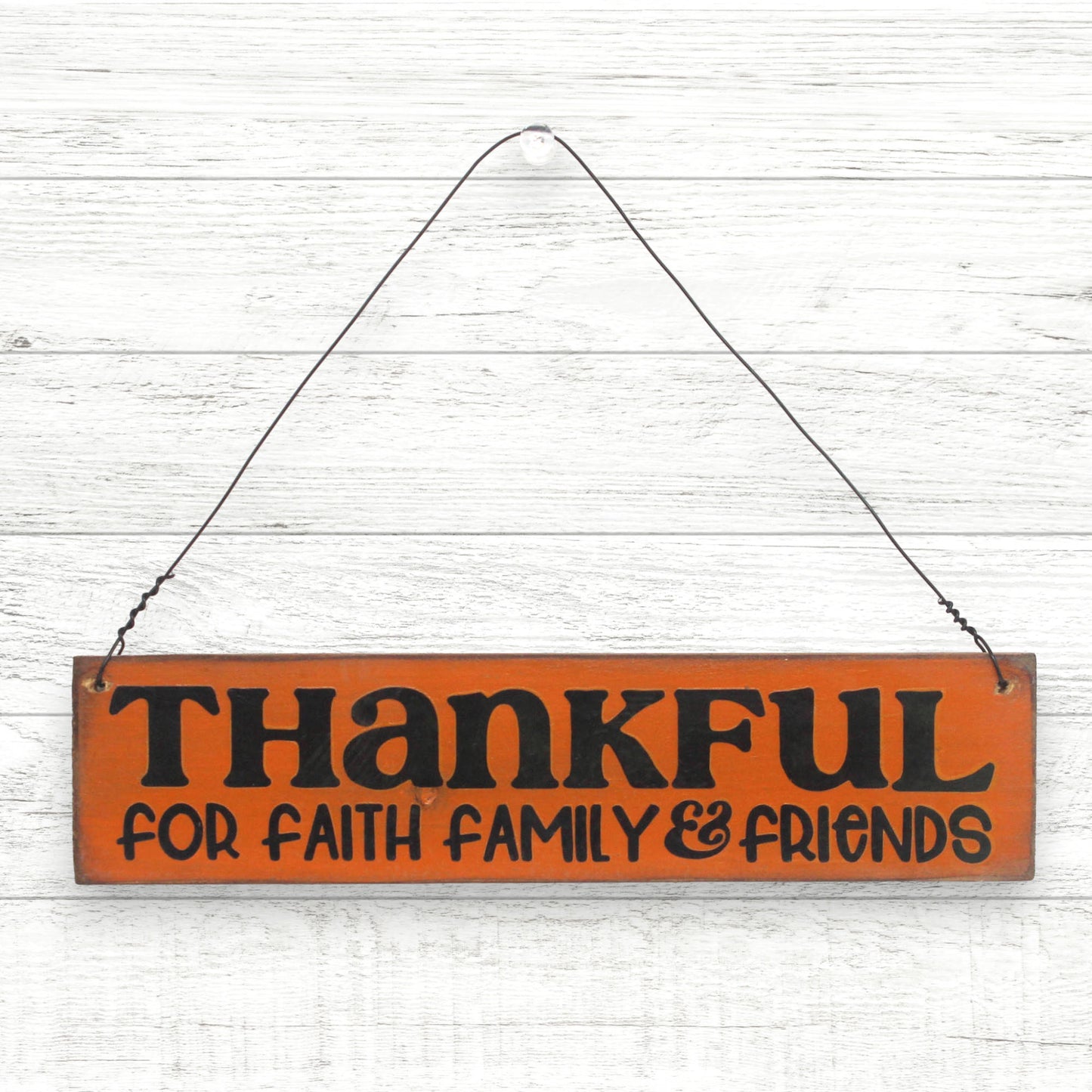 Handcrafted small wooden sign for autumn decorating that reads 'thankful for faith, family and friends'