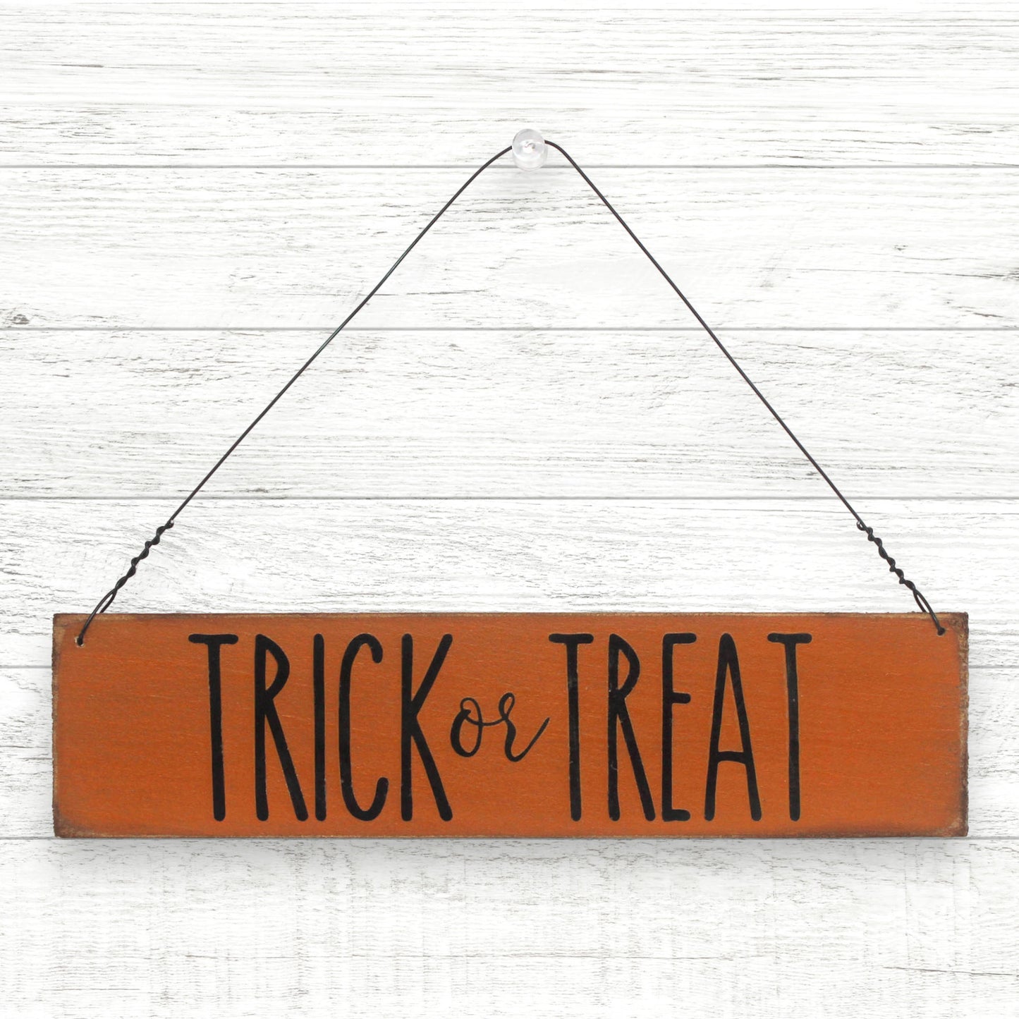 Small handcrafted wooden sign that reads 'trick or treat'