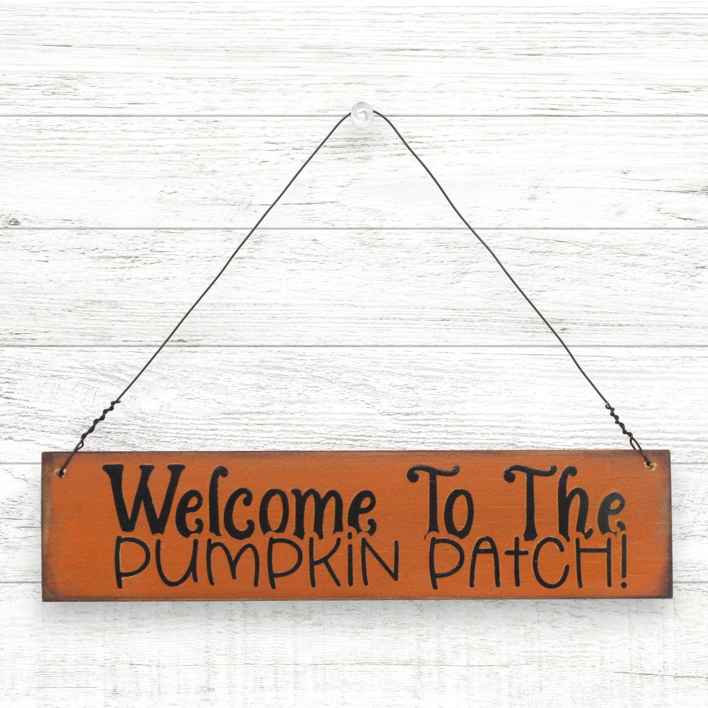 Small distressed wooden handcrafted sign which reads 'welcome to the pumpkin patch'