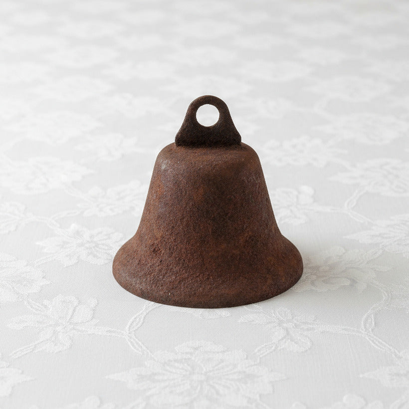 Rust-colored Liberty bell with a loop on a white background