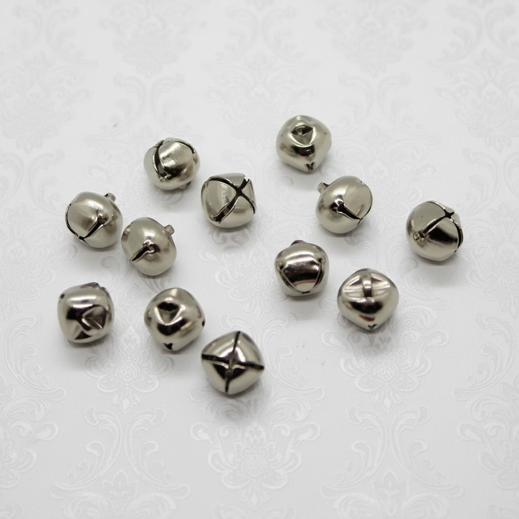 Silver bells scattered on a white background