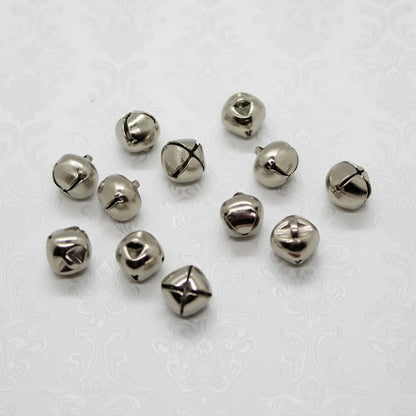 Silver bells scattered on a white background
