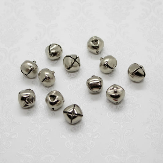 Silver bells scattered on a white background