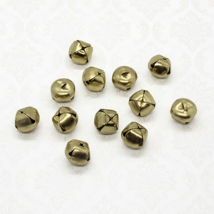 Gold toned jingle bells on a white background