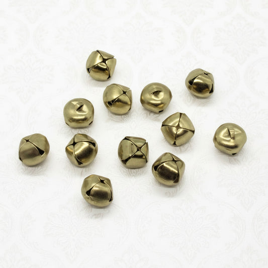 Gold toned jingle bells on a white background