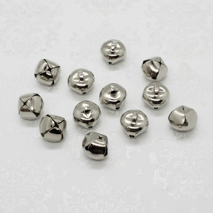 Silver jingle bells on a light gray background
