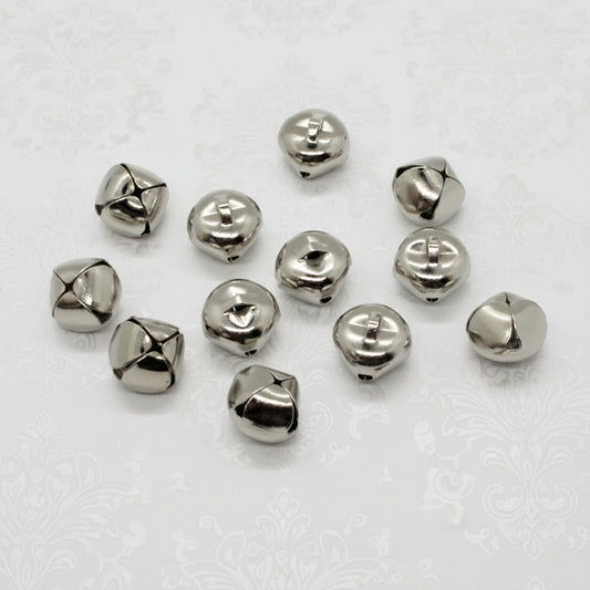 Silver jingle bells on a light gray background