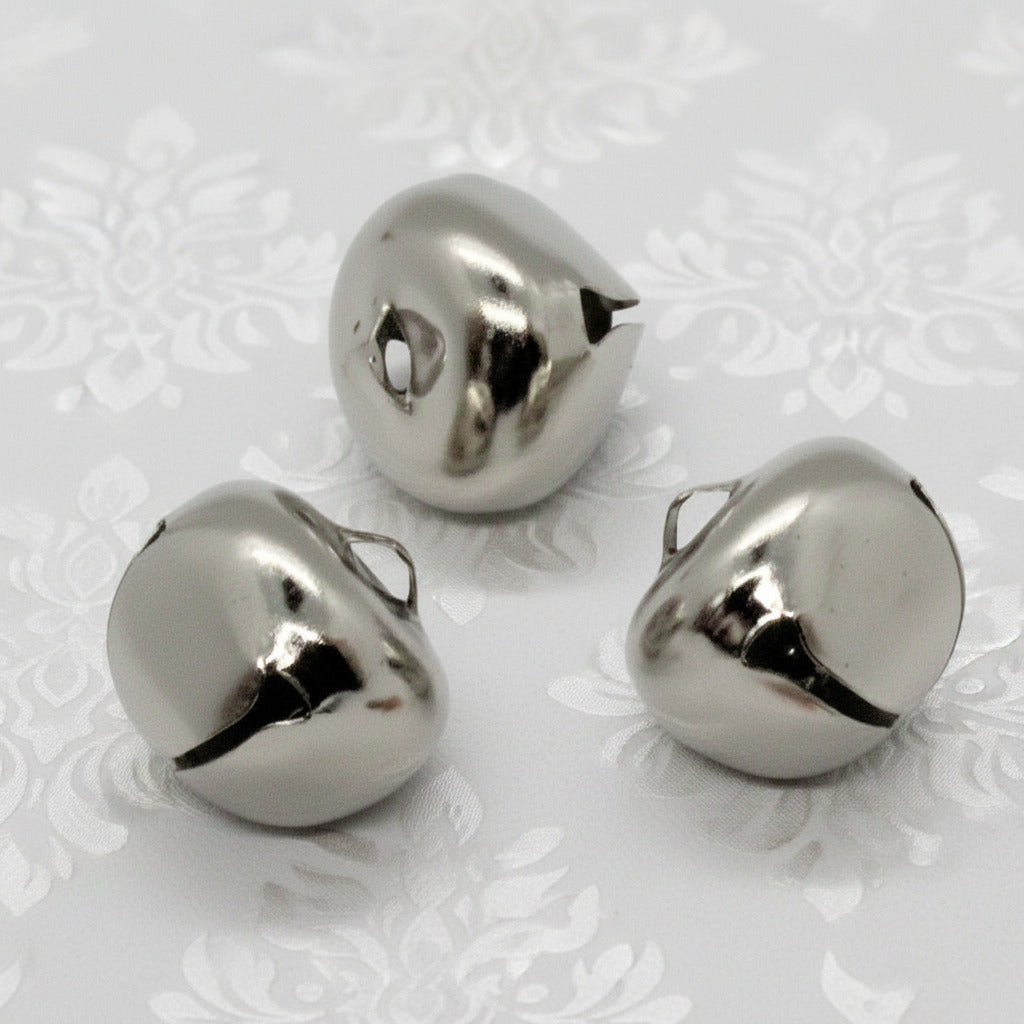 Three metallic bells on a white background