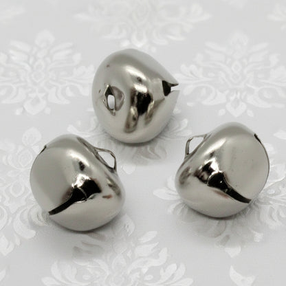 Three metallic bells on a white background