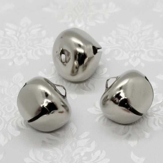 Three metallic bells on a white background
