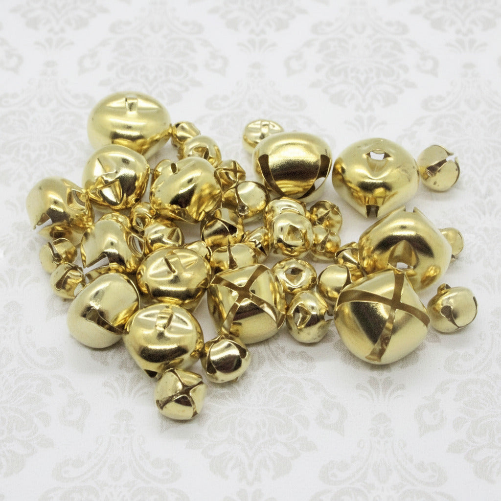 Gold metal jingle bells on a white background