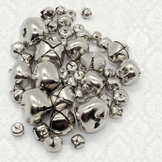 Pile of silver bells on a white background