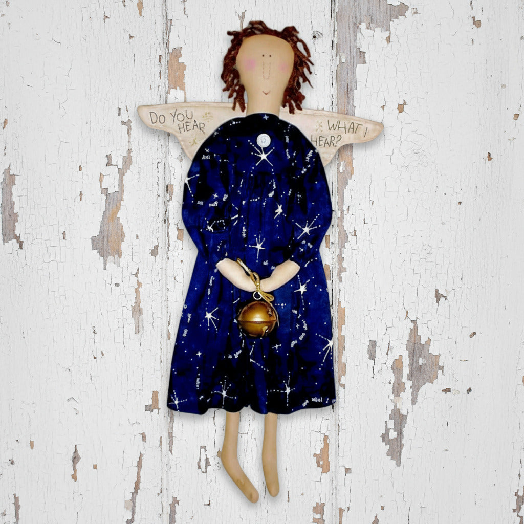 Angel doll with a blue dress featuring star patterns and a gold object, on a white background.