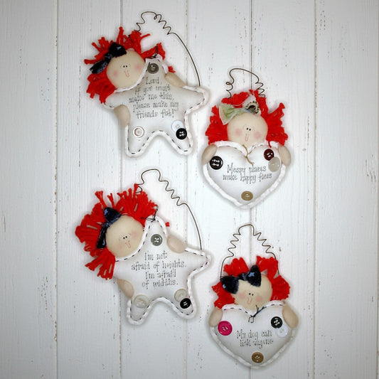 Set of four decorative raggedy dolls with red hair on a white background