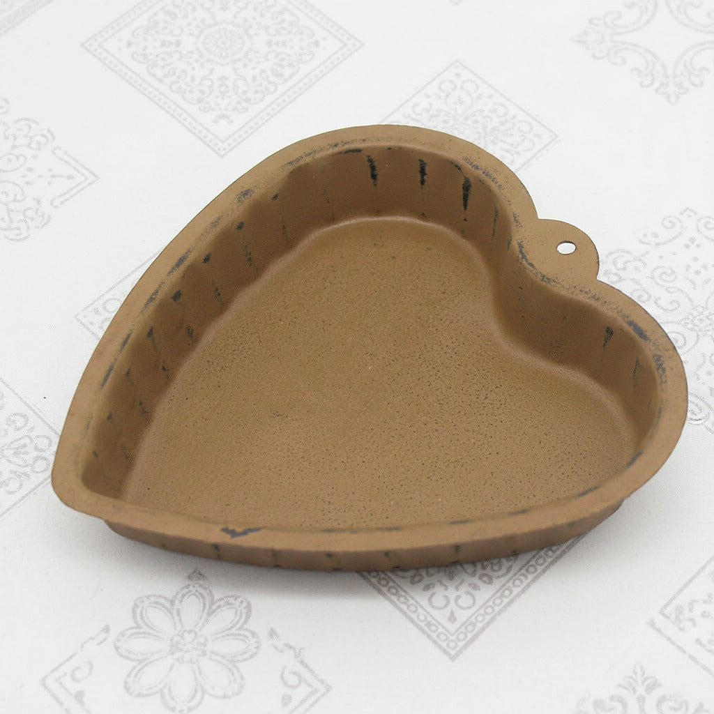 Heart-shaped mustard metal candle pan