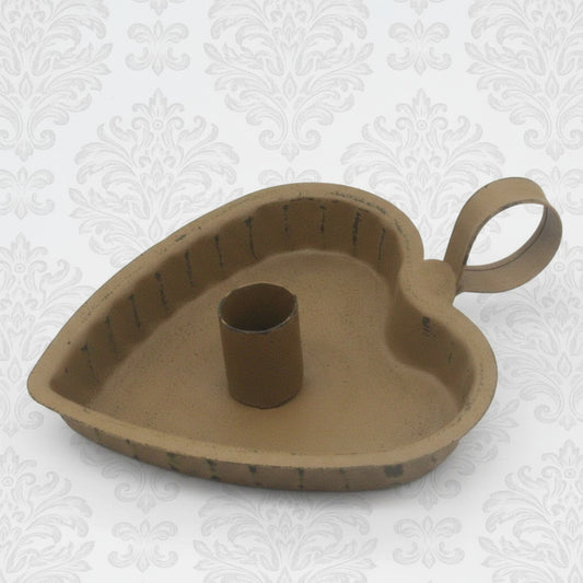 Heart-shaped metal candle holder on a white background