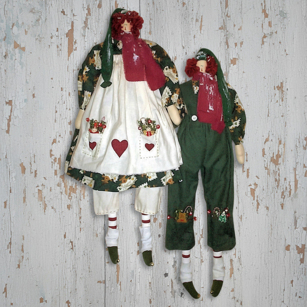 Pair of raggedy elf dolls dressed in hats, scarves and Christmas outfits