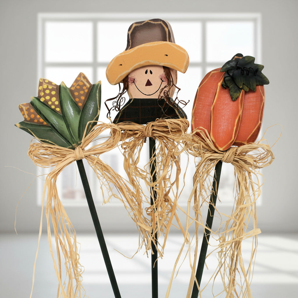 Decorative scarecrow and pumpkin wooden pokes on sticks with a white background