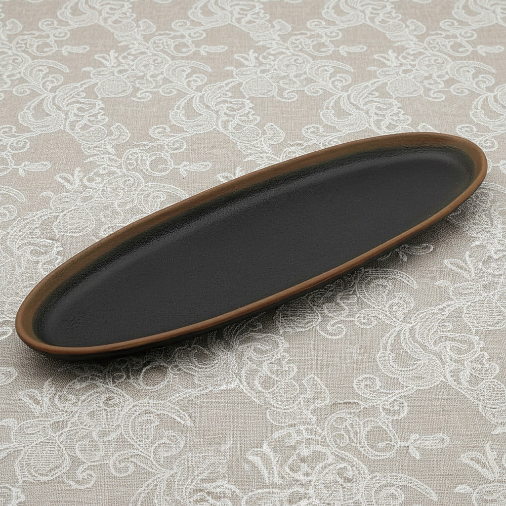 Black oval tray with brown rim on a white background
