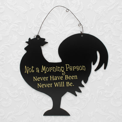 Black silhouette of a rooster with humorous text on a white background
