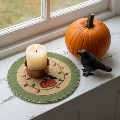 Felt candle mat with pumpkin and crow design