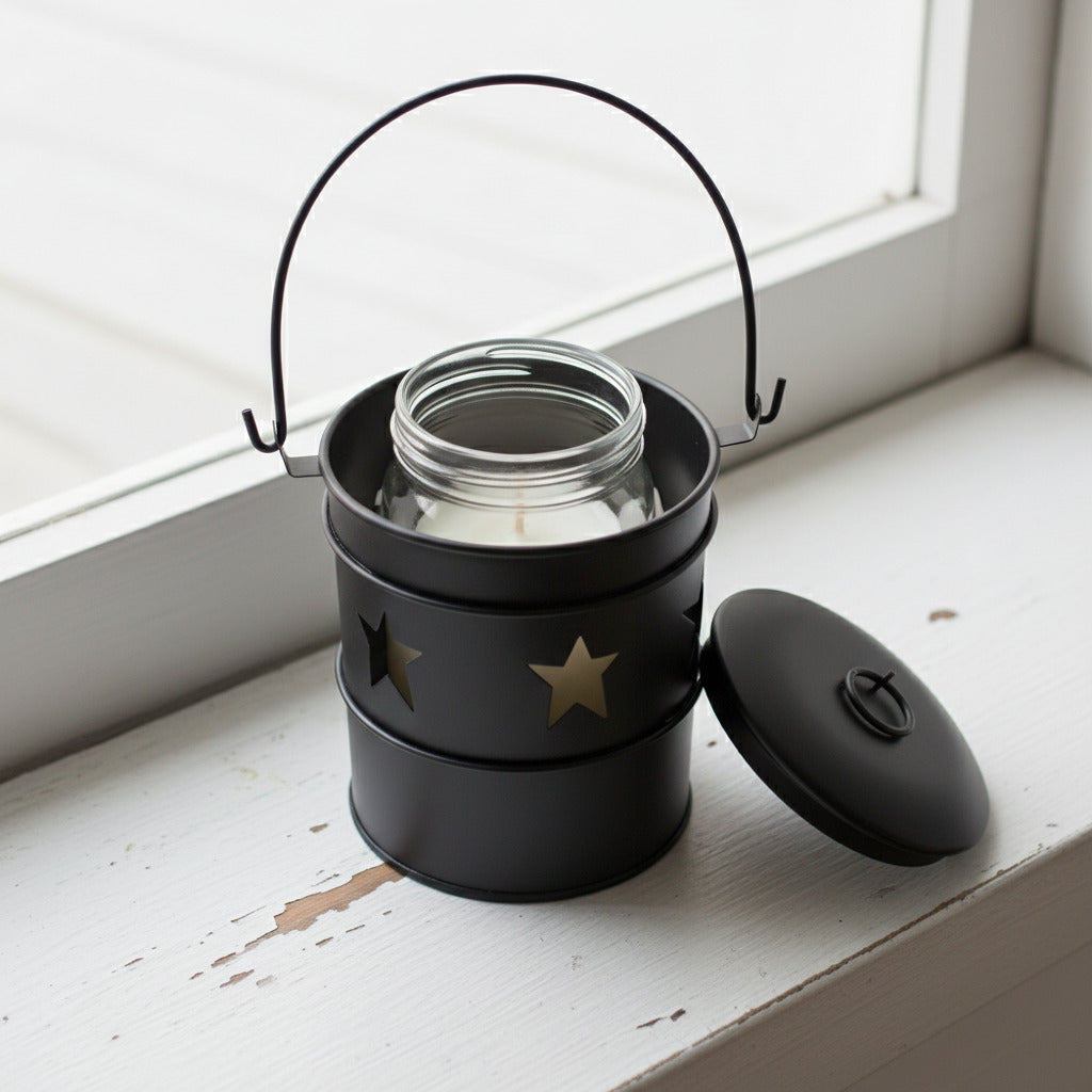 Black candle holder with star designs on a white background