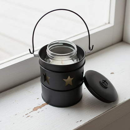 Black candle holder with star designs on a white background