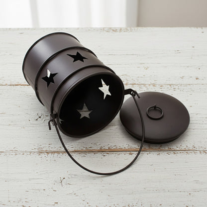 Black metal pail with star designs on a white background