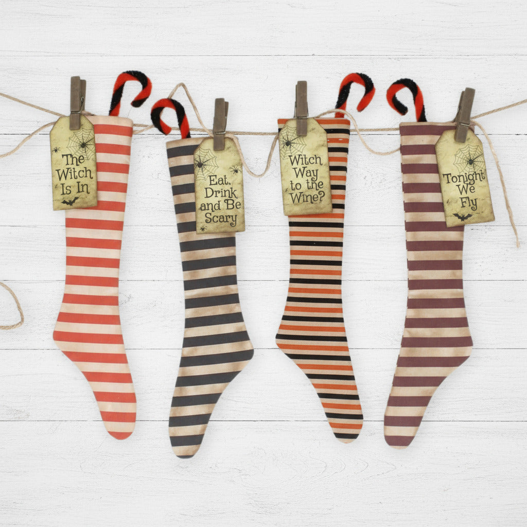 Set of four striped stockings with Halloween-themed sayings on a white background