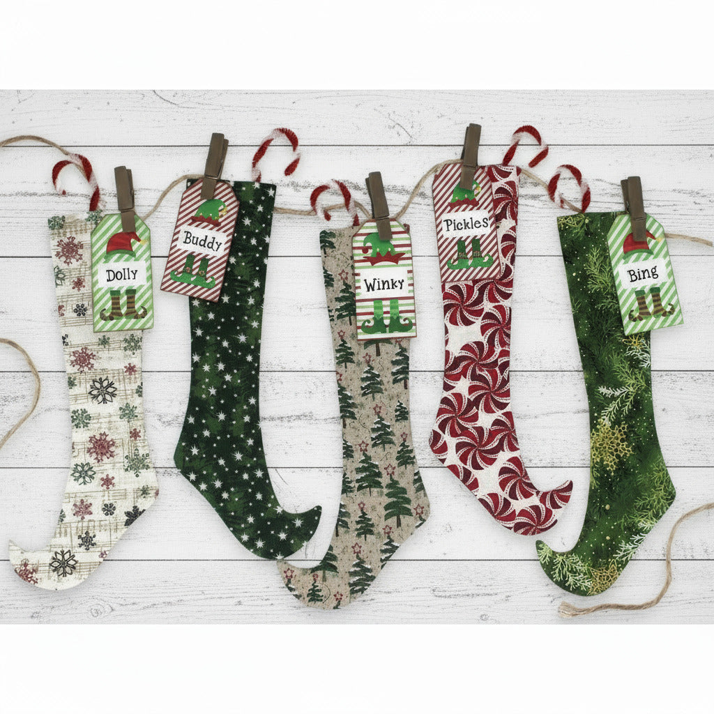 Set of personalized Christmas stockings hanging on a line with name tags.