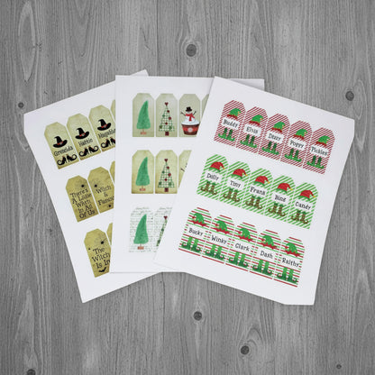 Set of Christmas-themed gift tags on white paper with a white background