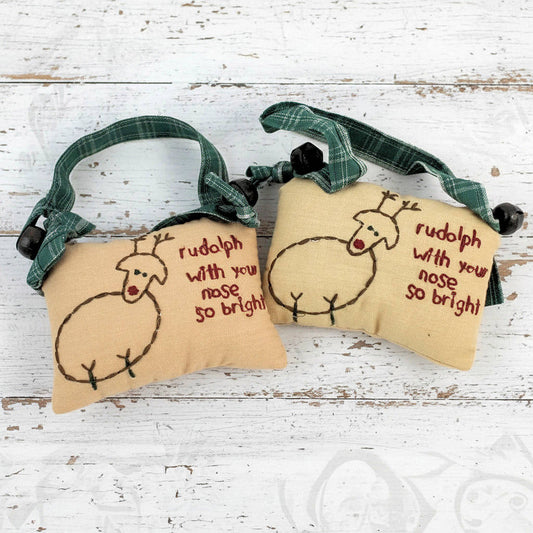 Set of two primitive reindeer stitchery pillow ornaments