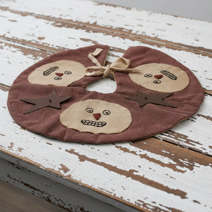 Primitive homespun mini Christmas tree skirt with snowman faces and rusty stars