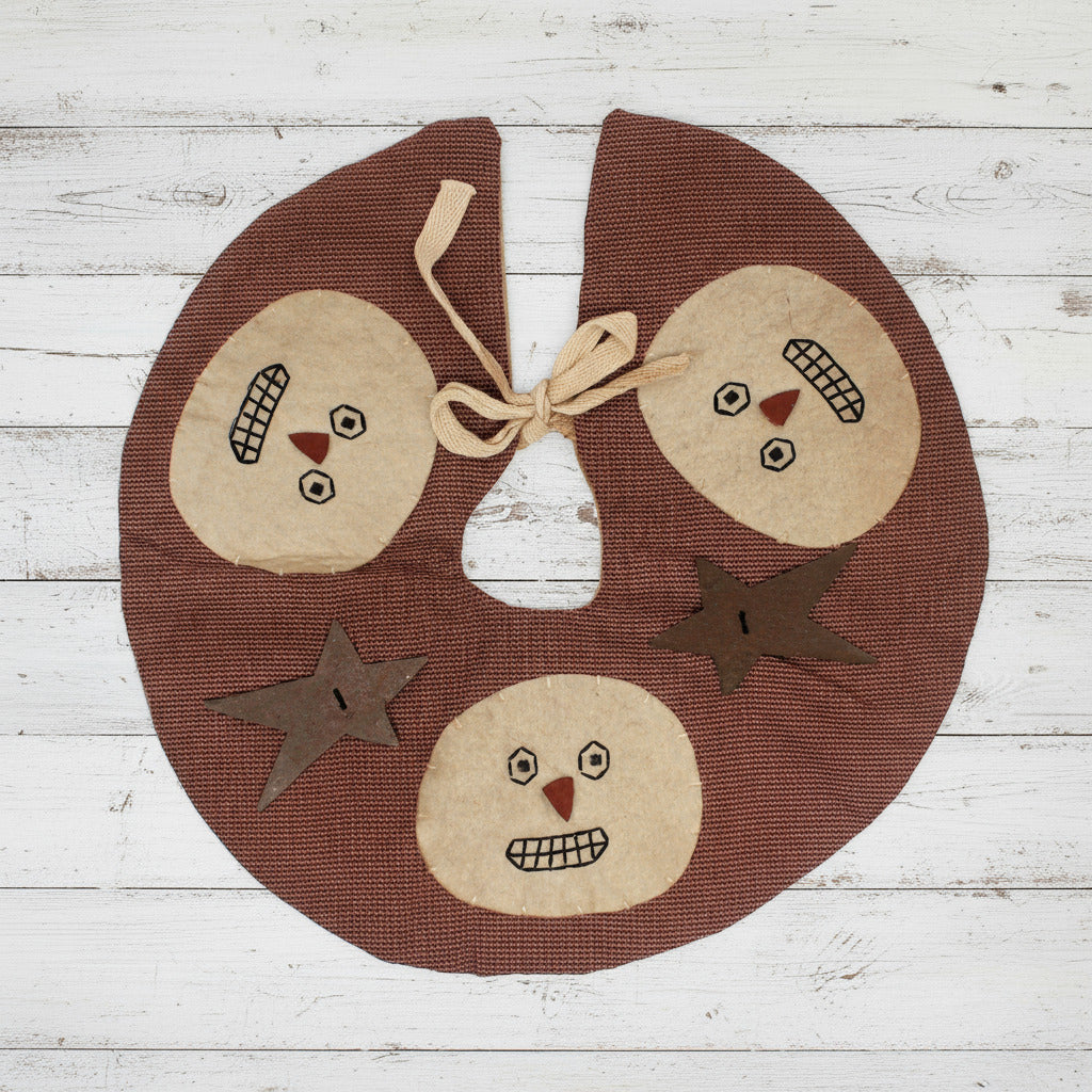 Primitive homespun mini Christmas tree skirt with snowman faces and rusty stars