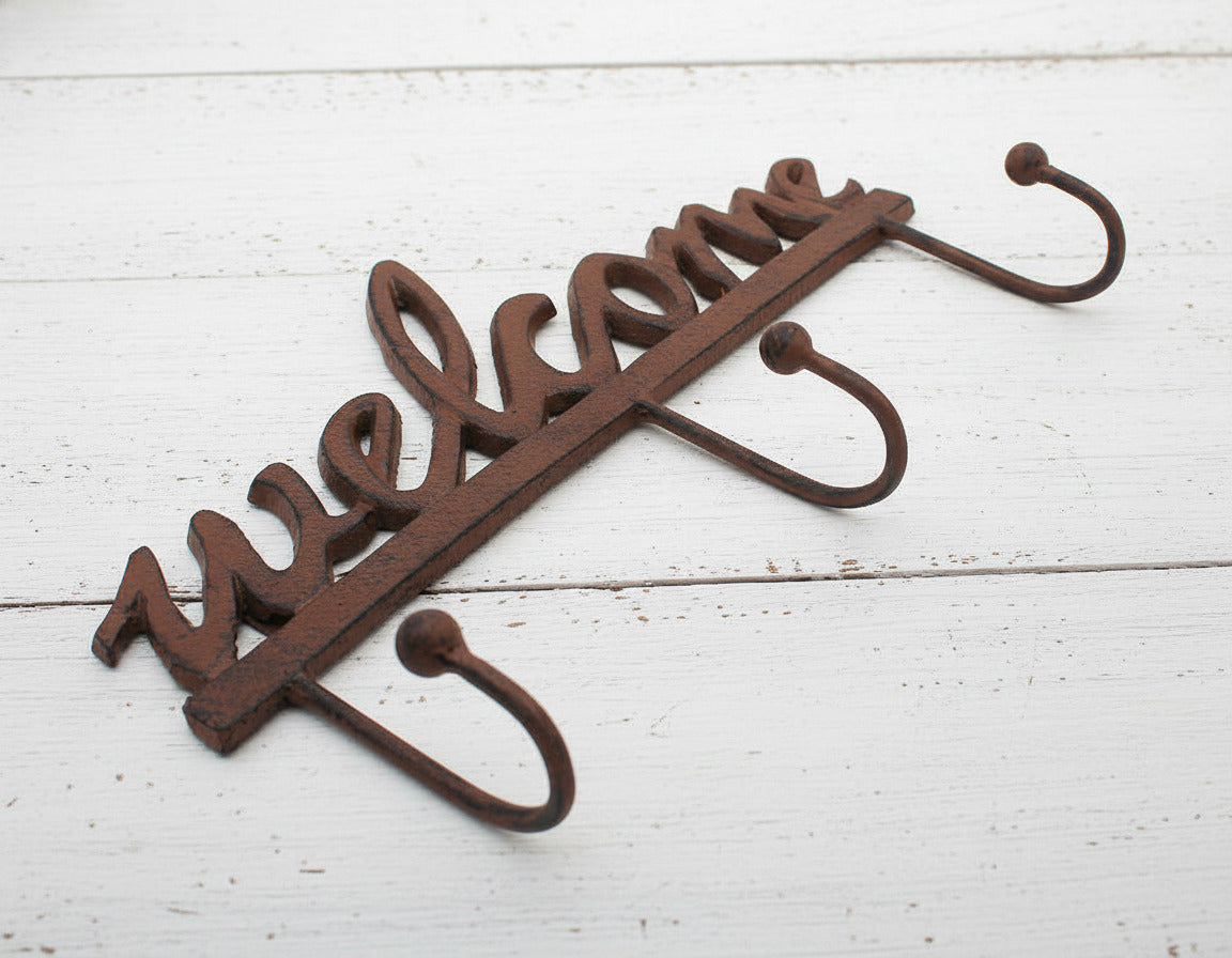 Decorative metal hook with 'Welcome' text on a white background