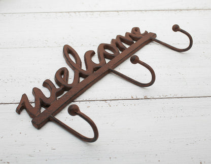Decorative metal hook with 'Welcome' text on a white background