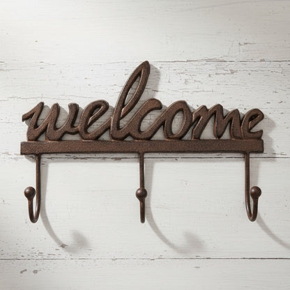 Decorative metal wall hook with 'welcome' text on a white background