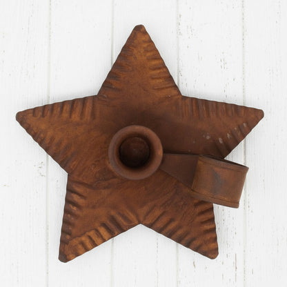 Star-shaped metal candle holder with a textured surface on a white background