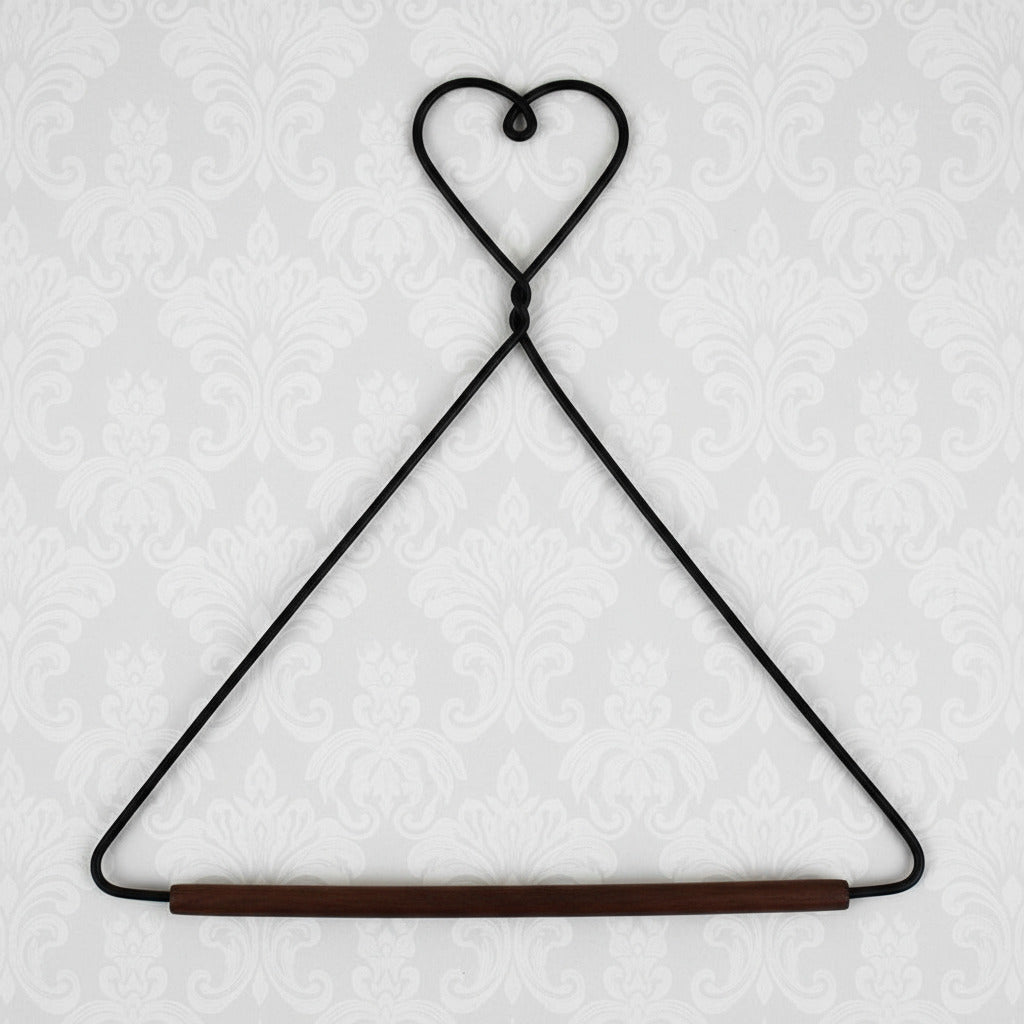 Black wire hanger with a wooden rod on a white background