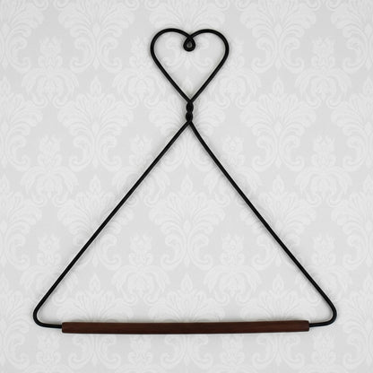 Black wire hanger with a wooden rod on a white background